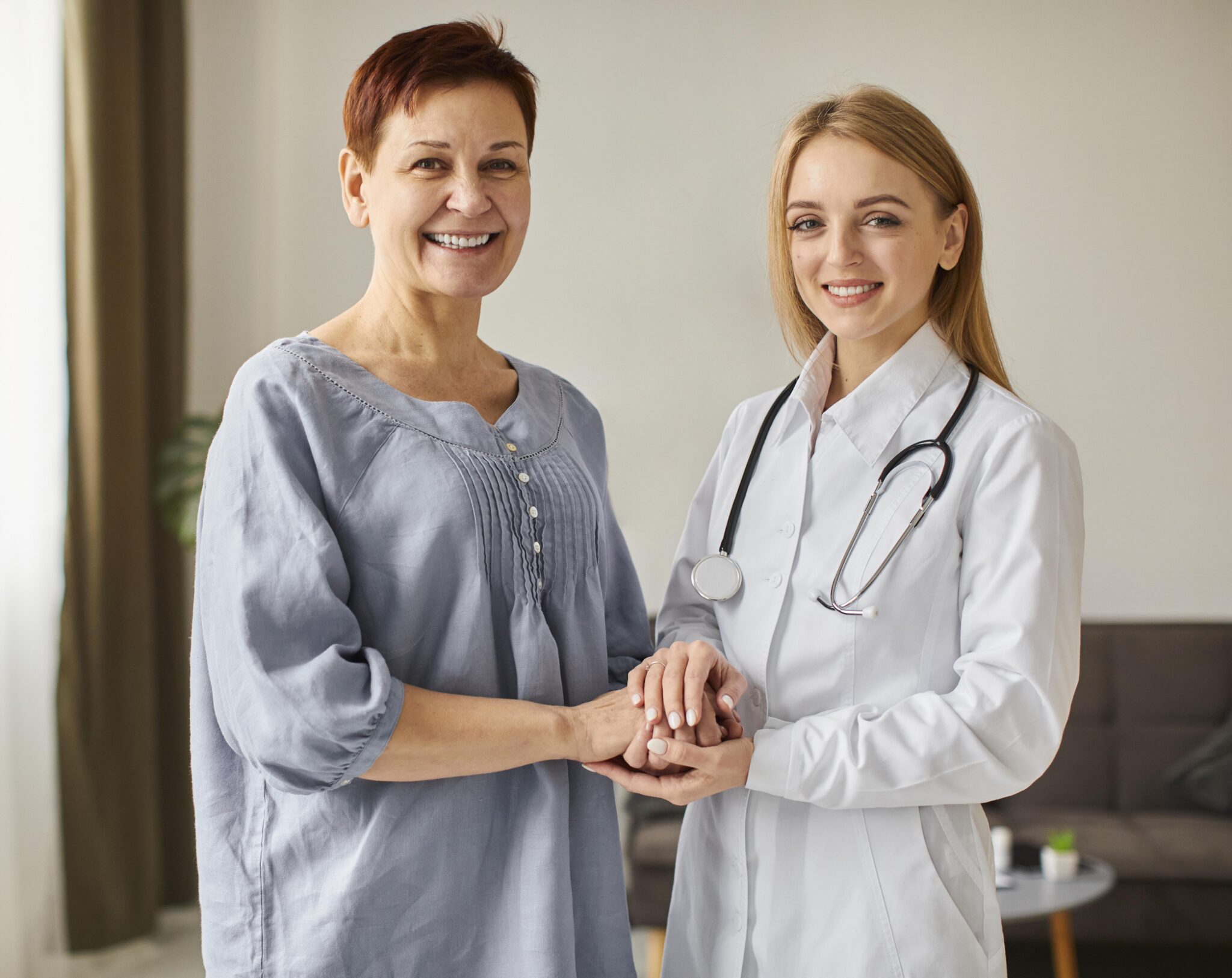 smiley-covid-recovery-center-female-doctor-holding-elder-patient-s-hands-2048×1626-1